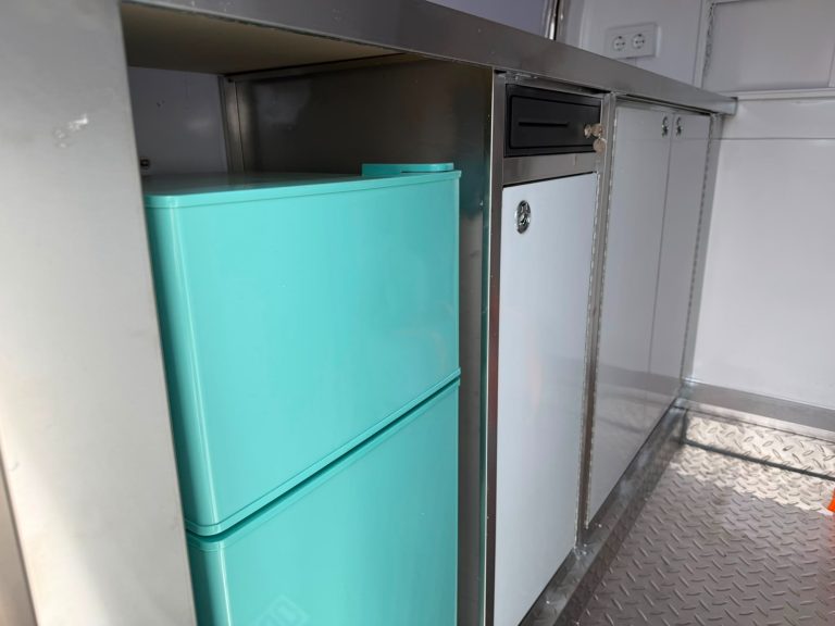Türaquamariner Kühlschrank neben einem weißen Kühlschrank in moderner Umgebung.