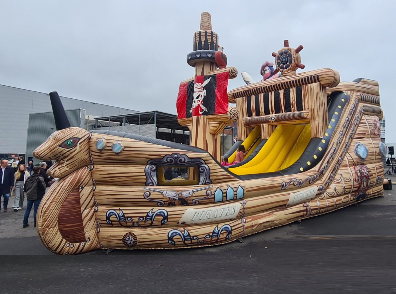 Piratenschiff - Hüpfburg-Rutsche Luftgeblasenes Piratenschiff mit Rutsche, farbenfroh gestaltet und im Freien aufgestellt.